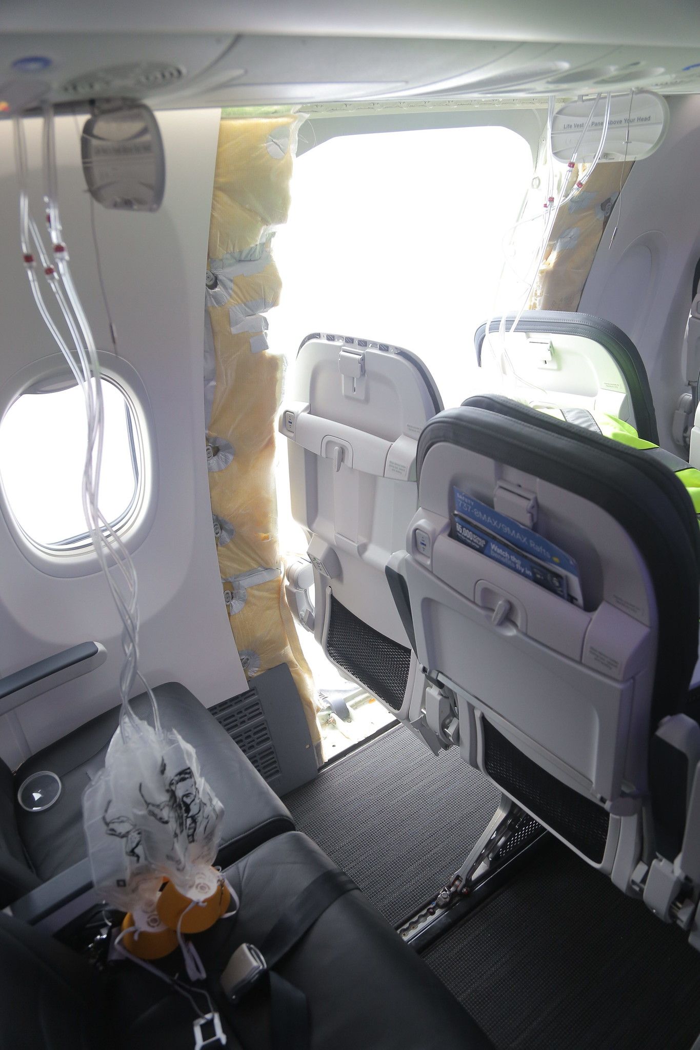 A close-up of an Alaska Airlines plane from the inside with the door blown out.